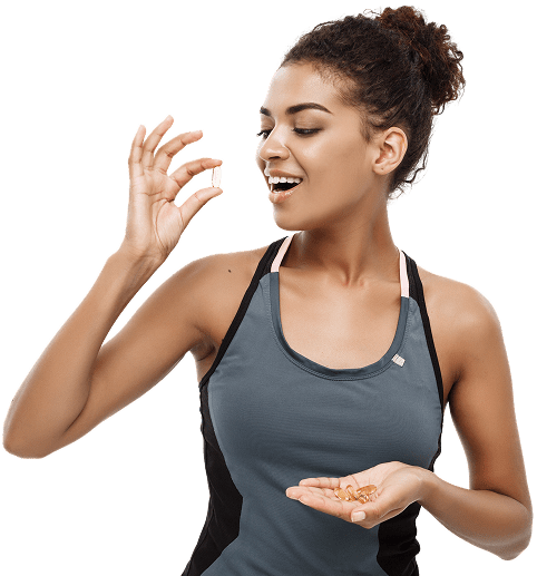 Person in a sleeveless top holds a handful of capsules in one hand while raising one capsule with the other, looking at it with interest.